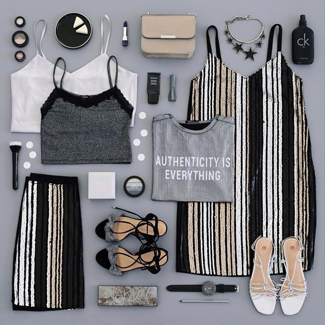 imagem flatlay com várias roupas e acessórios femininos em cores preto, branco e prateado
